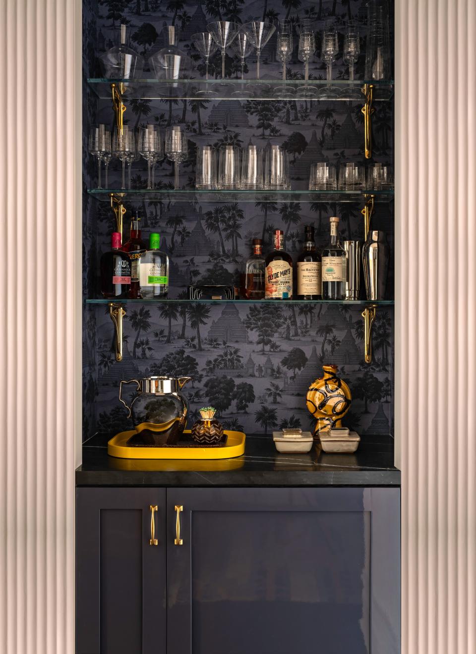 “This [home] is about you and your friends. What’s the first thing you do? You hang up their coat and you offer them a cocktail,” says Rockwell, who turned a closet in the foyer into a bar lined in Pierre Frey wallpaper and outfitted with a wine fridge, cocktail shakers, and Christofle glassware. “That’s New York City—a martini when you walk in the door in this fab, glossy foyer where everything is like jewelry.”