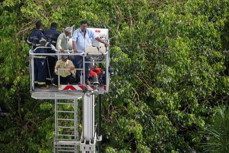 Firemen rescue people from Mahanagar Telephone Nigam Limited (MTNL) building after a fire broke out, in Mumbai