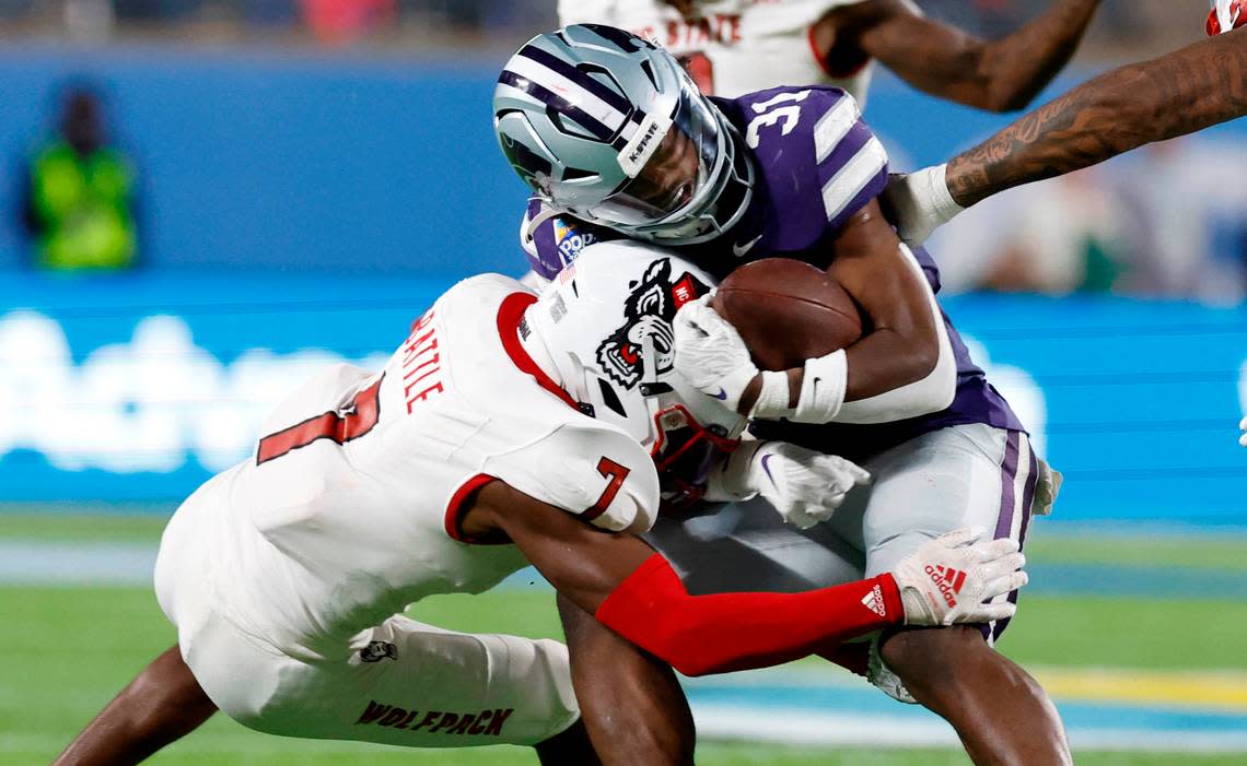 N.C. State’s Shyheim Battle (7) tackles Kansas State’s DJ Giddens (31) during the second half of Kansas State’s 28-19 victory over N.C. State in the Pop-Tarts Bowl at Camping World Stadium in Orlando, Fla., Thursday, Dec. 28, 2023. Ethan Hyman/ehyman@newsobserver.com