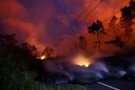 Volcanic gases rise from the Kilauea lava flow that crossed Pohoiki Road near Highway 132, near Pahoa, Hawaii, U.S., May 28, 2018. REUTERS/Marco Garcia