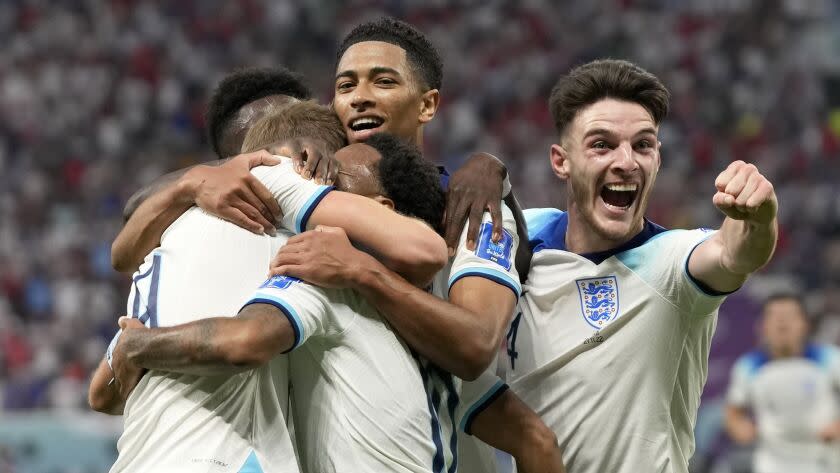 England's Raheem Sterling celebrates with teammates after scoring his side's third goal during the World Cup group B soccer match between England and Iran at the Khalifa International Stadium in Doha, Qatar, Monday, Nov. 21, 2022. (AP Photo/Frank Augstein)