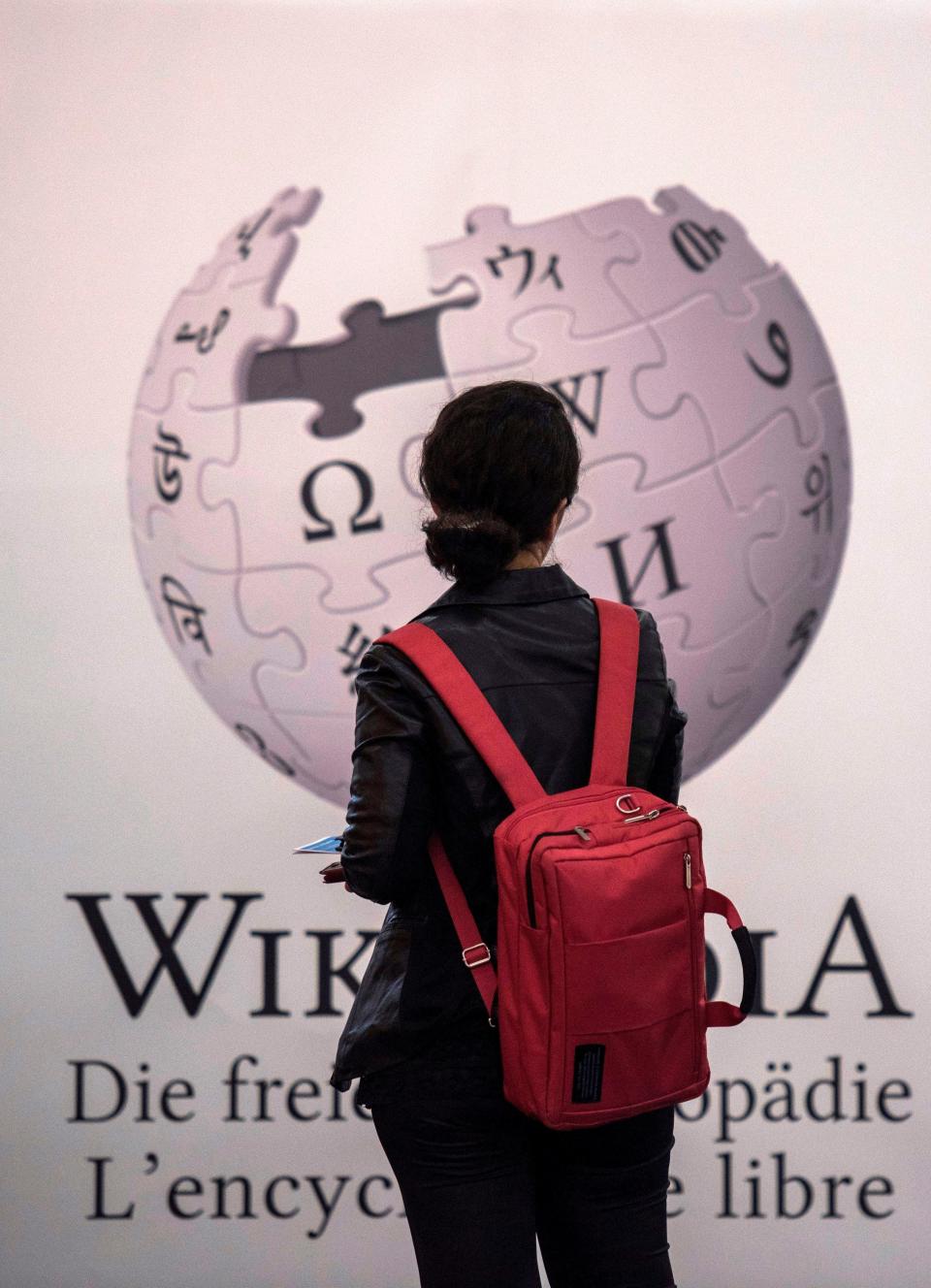 A visitor stands in front of the stand of online encyclopedia Wikipedia at the Frankfurt Book Fair on October 13, 2017 in Frankfurt am Main, western Germany. The website recently released its top 25 most viewed Wikipedia pages for 2023.