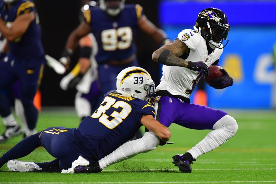 Nov 26, 2023; Inglewood, California, USA; Baltimore Ravens wide receiver Odell Beckham Jr. (3) moves the ball against <a class="link " href="https://sports.yahoo.com/nfl/teams/la-chargers/" data-i13n="sec:content-canvas;subsec:anchor_text;elm:context_link" data-ylk="slk:Los Angeles Chargers;sec:content-canvas;subsec:anchor_text;elm:context_link;itc:0">Los Angeles Chargers</a> cornerback <a class="link " href="https://sports.yahoo.com/nfl/players/34192" data-i13n="sec:content-canvas;subsec:anchor_text;elm:context_link" data-ylk="slk:Deane Leonard;sec:content-canvas;subsec:anchor_text;elm:context_link;itc:0">Deane Leonard</a> (33) during the first half at SoFi Stadium. Mandatory Credit: Gary A. Vasquez-USA TODAY Sports[/caption}