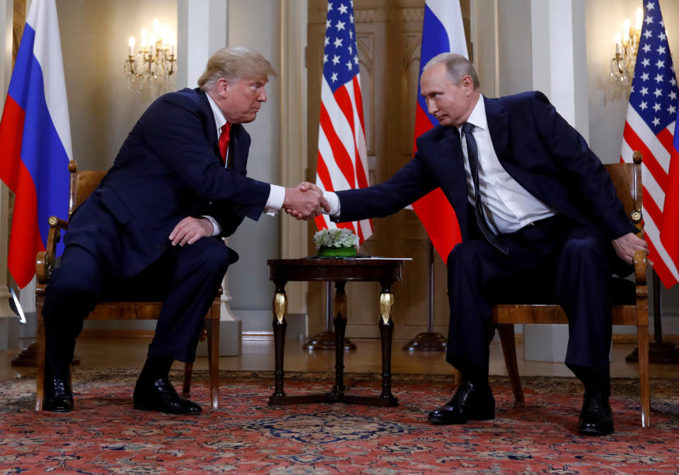 FILE PHOTO: U.S. President Donald Trump and Russia's President Vladimir Putin shake hands as they meet in Helsinki, Finland July 16, 2018. REUTERS/Kevin Lamarque/File Photo