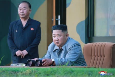 North Korean leader Kim Jong Un watches the test-fire of two short-range ballistic missiles