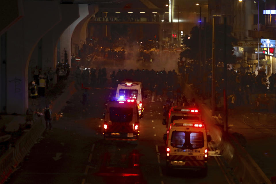 Riot policemen move towards protesters during a protest in Hong Kong, Sunday, July 28, 2019. Police fired tear gas at protesters in Hong Kong on Sunday for the second night in a row in another escalation of weeks-long pro-democracy protests in the semi-autonomous Chinese territory. (AP Photo/Vincent Yu)