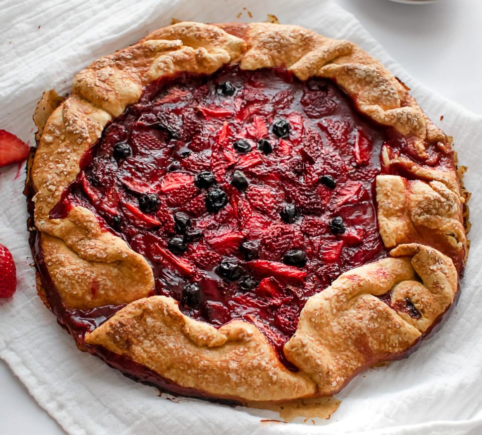 Rustic fruit crostata filled with sliced strawberries and blueberries