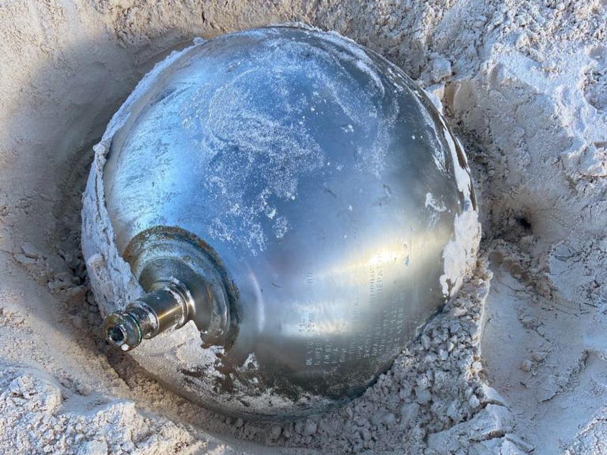 <p>Manon Clarke spotted the 41kg reflective ball poking out of the sand while walking with her family at Harbour Island</p> (Manon Clarke)