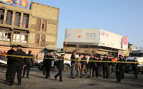 Iraqi security forces cordon off the area where a double suicide bombing  - Credit: SABAH ARAR /AFP