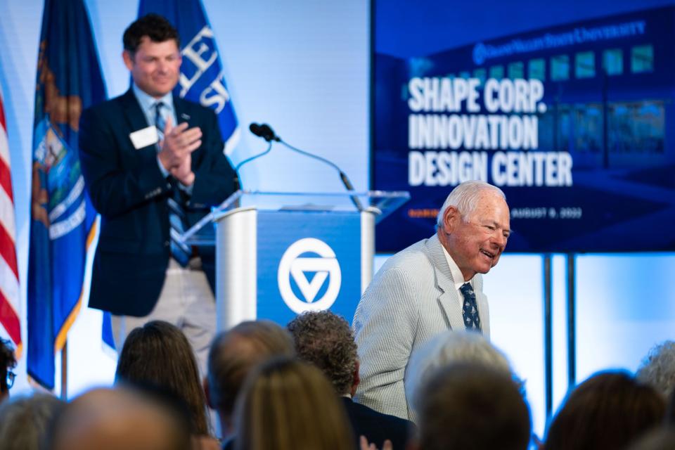 Attendees of the Shape Corp. Innovation Design Center naming ceremony applaud Midge Verplank, co-founder of Shape Corp., Tuesday, Aug. 9.