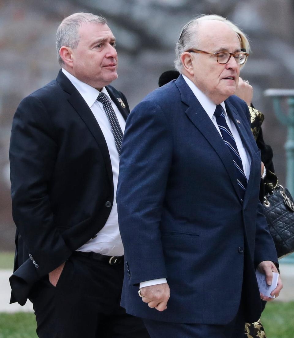 This photo shows the lawyer for US President Donald Trump, Rudy Giuliani, right, and a businessman who served as Giuliani's associate in Ukraine, Lev Parnas, left, as they arrived for the funeral of late US President George H.W. Bush at the National Cathedral in Washington, DC on December 5, 2018. (Photo by Alex Edelman / AFP via Getty Images)