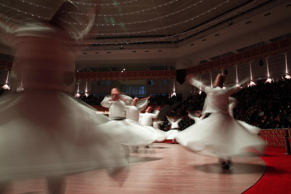In this photo taken on Sunday, Dec. 16, 2018, whirling dervishes of the Mevlevi order perform during a Sheb-i Arus ceremony in Konya, central Turkey. Every December the Anatolian city hosts a series of events to commemorate the death of 13th century Islamic scholar, poet and Sufi mystic Jalaladdin Rumi. (AP Photo/Lefteris Pitarakis)