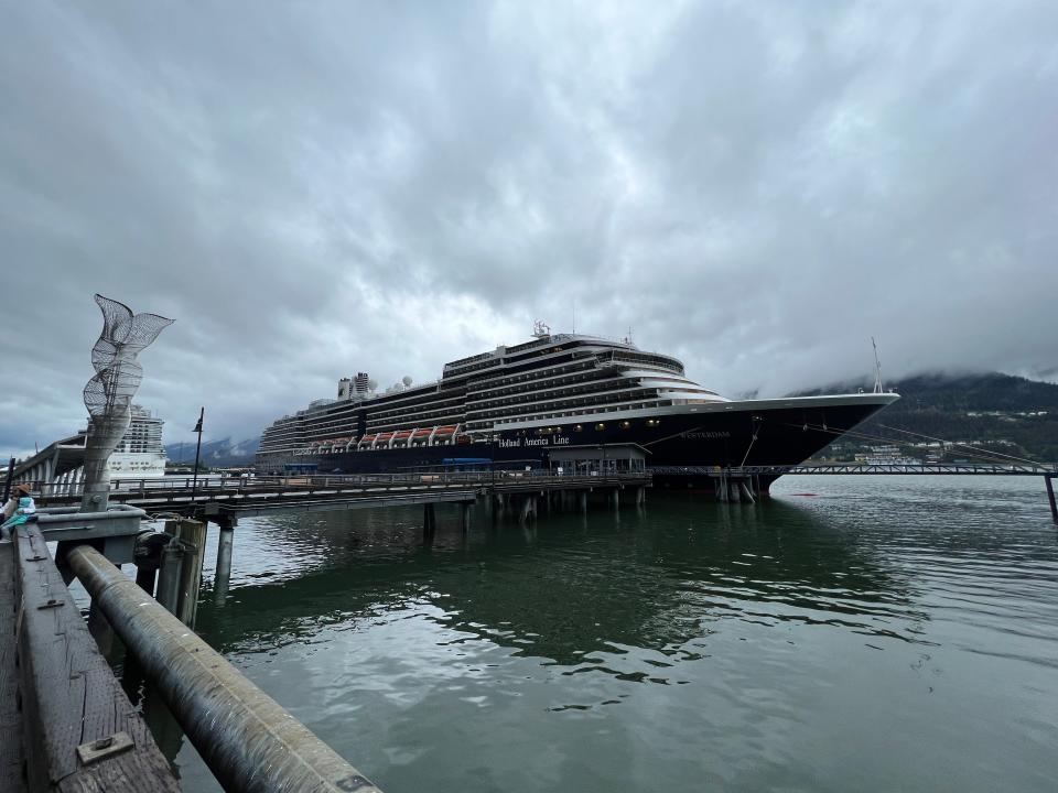 Holland America cruise docked in Alaska under stormy clouds