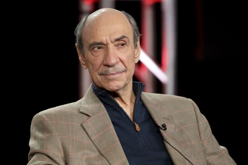 F. Murray Abraham in a brown blazer and a black shirt looking to his side