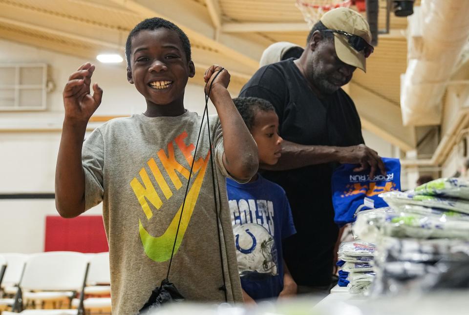 Indianapolis students pick out shirts, shoes and socks Tuesday, Aug. 29, 2023, during the Back to School Essential Giveaway to Empower Indianapolis Students at the JTV Hill Center in Indianapolis.