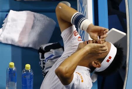 Japan's Kei Nishikori applies eye drops during his fourth round match against France's Jo-Wilfried Tsonga at the Australian Open tennis tournament at Melbourne Park, Australia, January 24, 2016. REUTERS/Jason Reed