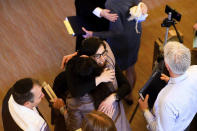 In this Saturday, Feb. 1, 2020, photo, Rabbi Jacqueline Mates-Muchin hugs a worshipper during Shabbat morning service at Temple Sinai in Oakland, Calif. Mates-Muchin says there’s extra worry as she feels obliged to be constantly mindful of her congregation’s safety. (AP Photo/Noah Berger)