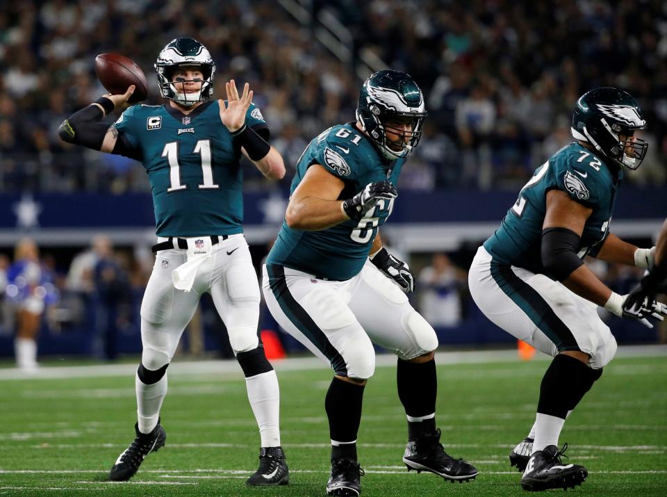 The Eagles' Stefen Wisniewski (61) and Halapoulivaati Vaitai protect quarterback Carson Wentz during the Birds' 37-9 win over the Cowboys on Nov. 19, 2017.