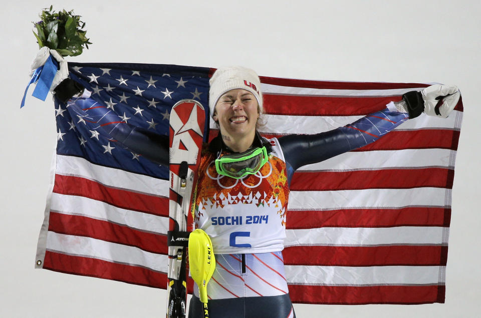 Women's slalom gold medal winner Mikaela Shiffrin of the United States poses for photographers with the American flag at the Sochi 2014 Winter Olympics, Friday, Feb. 21, 2014, in Krasnaya Polyana, Russia.(AP Photo/Christophe Ena)