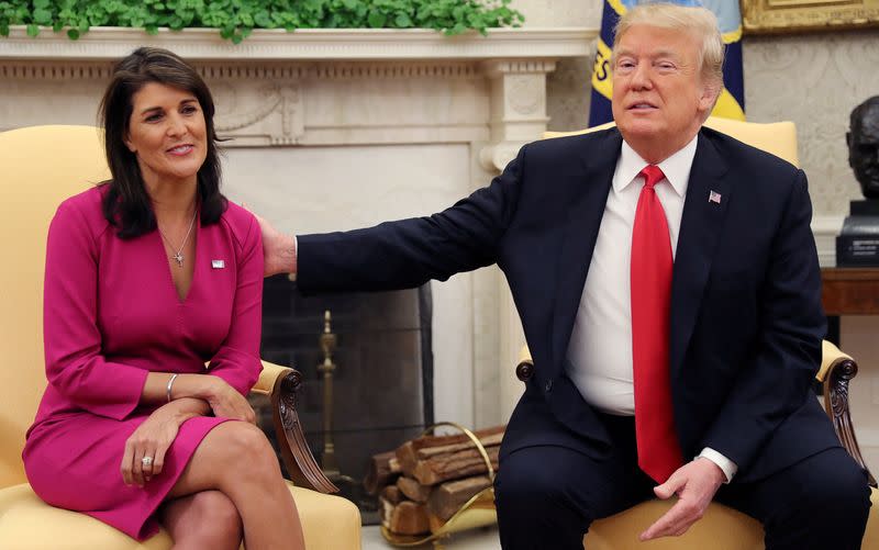 FILE PHOTO: U.S. President Trump reaches out to uutgoing U.S. Ambassador to the U.N. Haley as they meet in the Oval Office of the White House in Washington