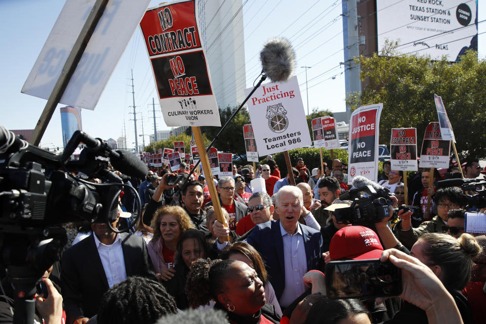 FILE - In this Feb. 19, 2020, file photo, Democratic presidential candidate, former Vice President Joe Biden calls out as he walks on a picket line with members of the Culinary Workers Union Local 226 outside the Palms Casino in Las Vegas. If Nevada has one job in the Democratic primary, it's to offer something different. And in many ways it has delivered. As the presidential race turned to the state this week, gone was the earnestness of Iowa and tradition of New Hampshire and in its place was racial diversity, a new unpredictability and the muscle of urban, union politics. (AP Photo/Patrick Semansky, File)