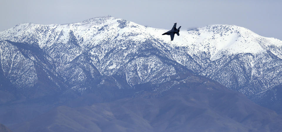 In this Feb. 27, 2017, photo, an F/A-18E Super Hornet from VFA-24 squadron at NAS Lemoore banks in front of the Panamint range while exiting the nicknamed Star Wars Canyon on the Jedi transition over Death Valley National Park, Calif. Military jets roaring over national parks have long drawn complaints from hikers and campers. But in California's Death Valley, the low-flying combat aircraft skillfully zipping between the craggy landscape has become a popular attraction in the 3.3 million acre park in the Mojave Desert, 260 miles east of Los Angeles. (AP Photo/Ben Margot)