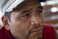 Mynor Cardona, Yenifer Yulisa Cardona Tomás' father, listens to a question during an interview in Guatemala City, Monday, July 4, 2022. Yenifer Yulisa Cardona Tomás is one of the survivors of the more than 50 migrants who were found dead inside a tractor-trailer near San Antonio, Texas. (AP Photo/Oliver de Ros)