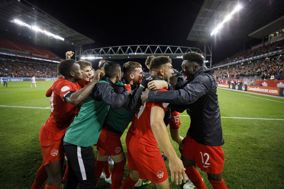 Canada midfielder Alphonso Davies (12) looks at forward Lucas Cavallini as they celebrate Cavallini's goal against the United States during the second half of a CONCACAF Nations League soccer match Tuesday, Oct. 15, 2019, in Toronto. (Cole Burston/The Canadian Press via AP)