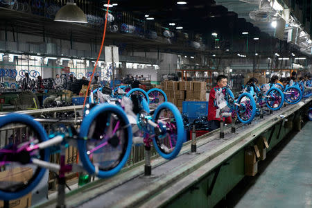 Employees work on the production line of Kent bicycles at Shanghai General Sports Co., Ltd, in Kunshan, Jiangsu Province, China, February 22, 2019. Picture taken February 22, 2019. REUTERS/Aly Song