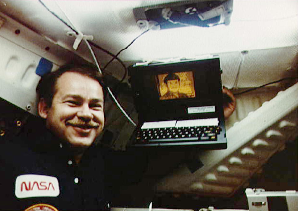 In this June 18, 1985 photo made available by NASA, Astronaut John Creighton poses with the onboard Graphical Retrieval Information Display (GRID) computer, which displays a likeness of the character Mr. Spock from Star Trek. Bill Moggridge, who designed the GRID computer, an early portable with a flip-open shape that is common today, has died. He was 69. The Smithsonian's Cooper-Hewitt, National Design Museum said Moggridge, its director since 2010, died on Saturday, Sept. 8, 2012 after a battle with cancer. (AP Photo/NASA)