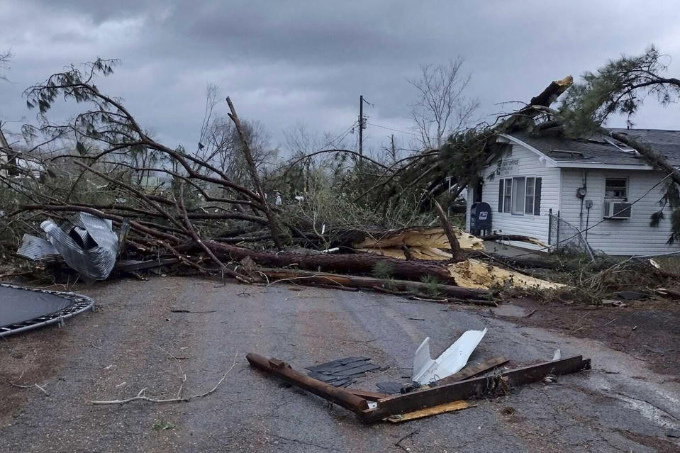 Debris covers the ground as homes are damaged after severe weather in Glen Allen, Mo., on Wednesday, April 5, 2023. A large tornado tore through southeastern Missouri before dawn on Wednesday, killing several people and causing widespread destruction. (Courtesy of Josh Wells via AP)