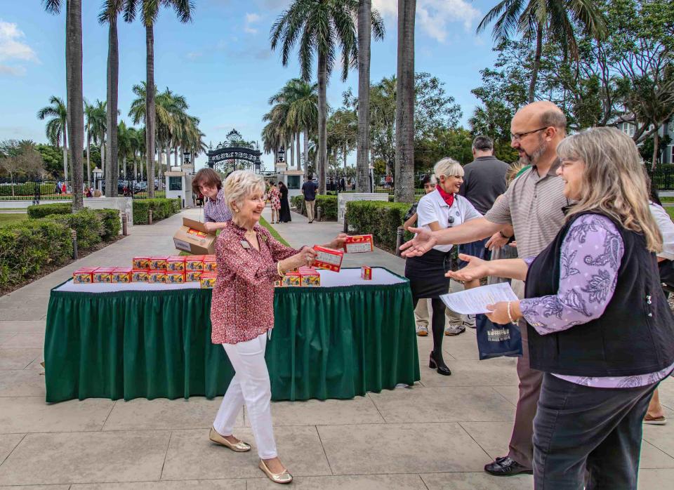 People receive boxes of animal crackers after attending the Flagler Museum's annual Christmas celebration.