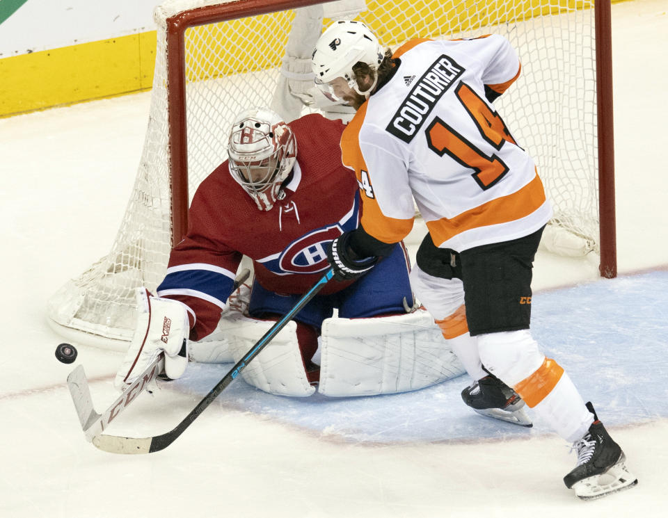 Montreal Canadiens goaltender Carey Price (31) makes a save on Philadelphia Flyers center Sean Couturier (14) during the second period of an NHL Stanley Cup playoff hockey game in Toronto, Friday, Aug. 21, 2020. (Frank Gunn/The Canadian Press via AP)