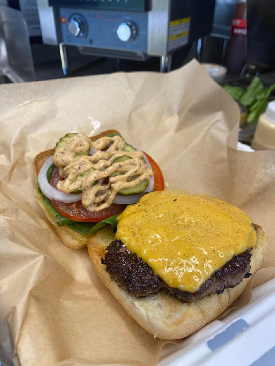 The Top Bun ‘Jester’ is a top-seller, it is a 1/3 lb grass fed burger, topped with your choice of cheese, lettuce, tomato, onion, pickles, served with the “top bun” sauce.