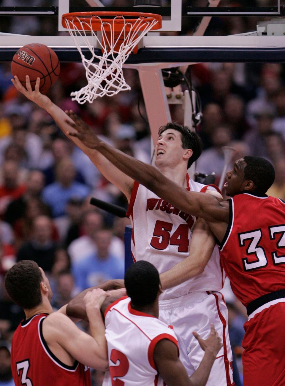 Wisconsin's Mike Wilkinson lays in two points as NC State's Cedric Simmons tries to defend the shot in the second half of a NCAA Tournament game.