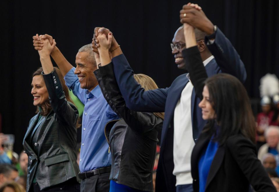 Former President Barack Obama holds hands alongside Michigan Governor Gretchen Whitmer, Lieutenant Governor of Michigan Garlin Gilchrist ll, Secretary of State of Michigan Jocelyn Benson, and Michigan Attorney General Dana Nessel during a rally inside a gymnasium at Renaissance High School in Detroit on Saturday, Oct. 29, 2022. 