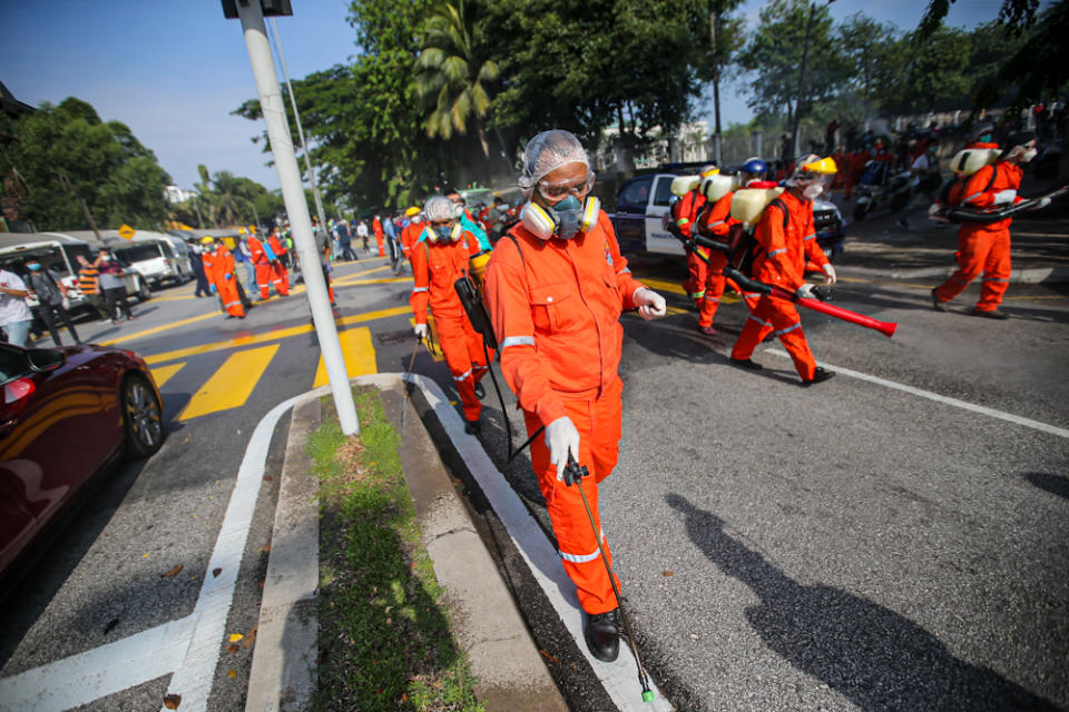 DBKL and Alam Flora personnel sanitise the area around the Sri Petaling Mosque March 28, 2020.