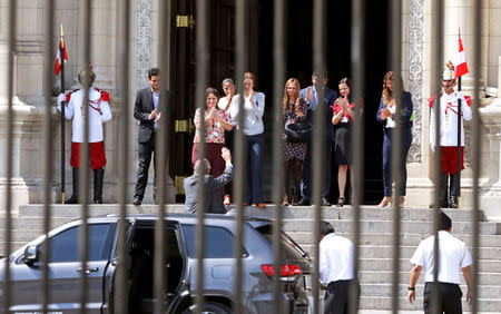 Peru's President Pedro Pablo Kuczynski waves to staff as he leaves Government Palace after presenting his resignation to Congress in Lima, Peru March 21, 2018. REUTERS/Mariana Bazo