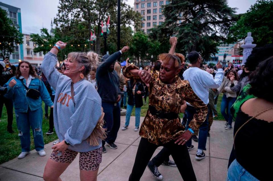 Alicia Francies, left, Marsha Deas dance to live music at Cesar Chavez Plaza on opening night of the Concerts in the Park, a three-month free concert series that began on Cinco de Mayo.