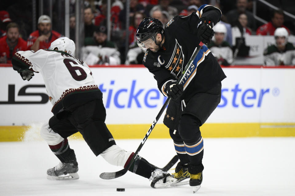 Washington Capitals left wing Alex Ovechkin, right, battles for the puck against Arizona Coyotes left wing Lawson Crouse (67) during the first period of an NHL hockey game, Saturday, Nov. 5, 2022, in Washington. (AP Photo/Nick Wass)