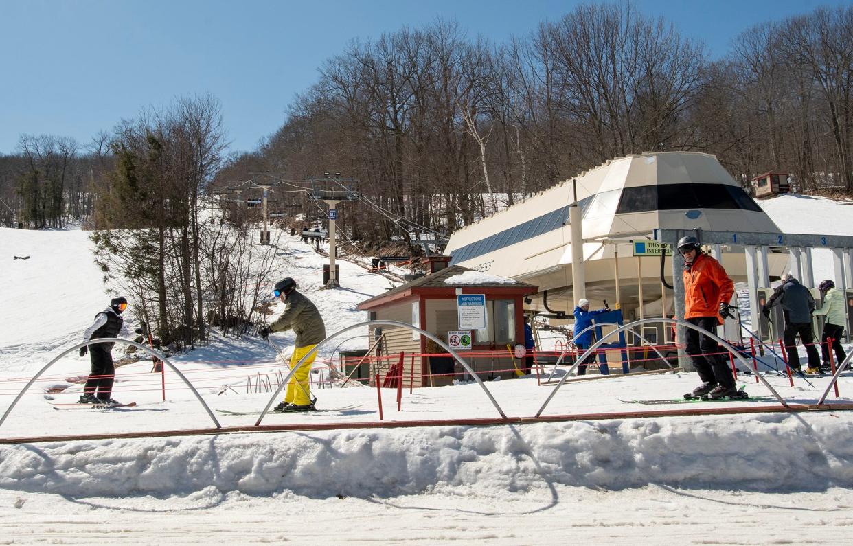 Skiers get in line for the Minuteman Express, one of the lifts at Wachusett Mountain on Monday.