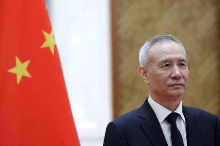 FILE PHOTO: Chinese Vice Premier Liu He waits to shake hands with European Commission Vice President Jyrki Katainen ahead of the EU-China High-level Economic Dialogue at Diaoyutai State Guesthouse in Beijing, China, June 25, 2018. REUTERS/Jason Lee