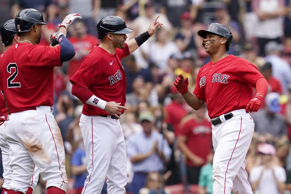 Boston Red Sox's Rafael Devers, right, celebrates his three-run homer with J.D. Martinez, center, and Xander Bogaerts (2) in the sixth inning of a baseball game against the Kansas City Royals at Fenway Park, Thursday, July 1, 2021, in Boston. (AP Photo/Elise Amendola)