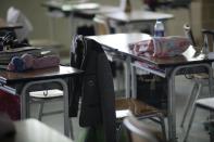 Personal items belonging to students who were on the sinking ferry sit inside an empty classroom of Danwon High School in Ansan, South Korea, Thursday, April 17, 2014. Strong currents, rain and bad visibility hampered an increasingly anxious search Thursday for 287 passengers, many thought to be high school students, still missing more than a day after their ferry flipped onto its side and sank in cold waters off the southern coast of South Korea. (AP Photo/Woohae Cho)