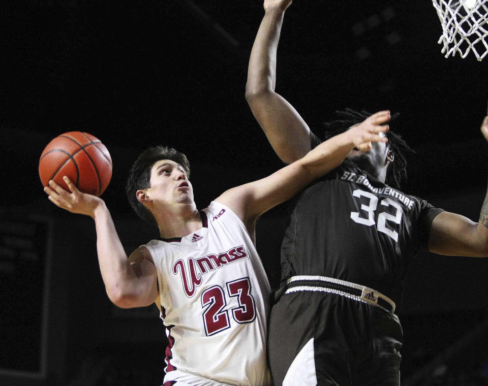 UMass' Josh Cohen goes to the basket against St. Bonaventure's Chad Venning during the second half of an NCAA college basketball game Saturday, Feb. 24, 2024, in Amherst, Mass. (J. Anthony Roberts/The Republican via AP)