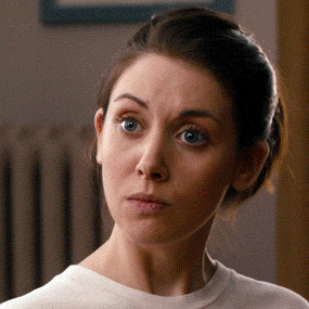 Alison Brie with a surprised expression