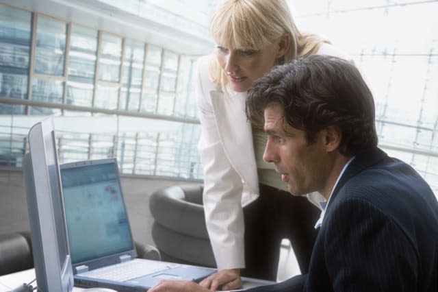 Man and Woman working with a computer in a office