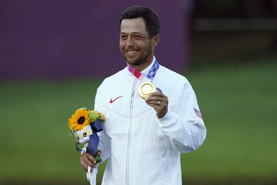 Xander Schauffele, of the United States, holds his gold medal after winning the men's golf event at the 2020 Summer Olympics, Sunday, Aug. 1, 2021, at the Kasumigaseki Country Club in Kawagoe, Japan, (AP Photo/Matt York)