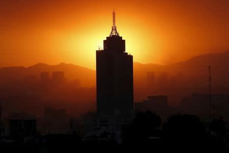 The sun sets behind the World Trade Center building in Mexico City March 14, 2016. REUTERS/Edgard Garrido