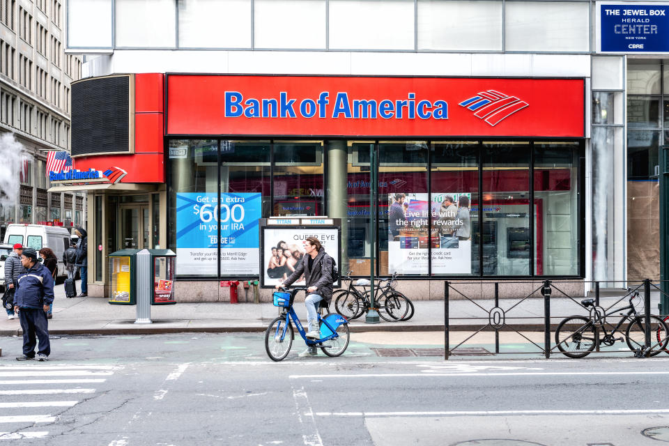 New York, USA - April 7, 2018: Street view on Bank of America branch in NYC with people waiting, pedestrians crossing, crosswalk, bike, road in Manhattan